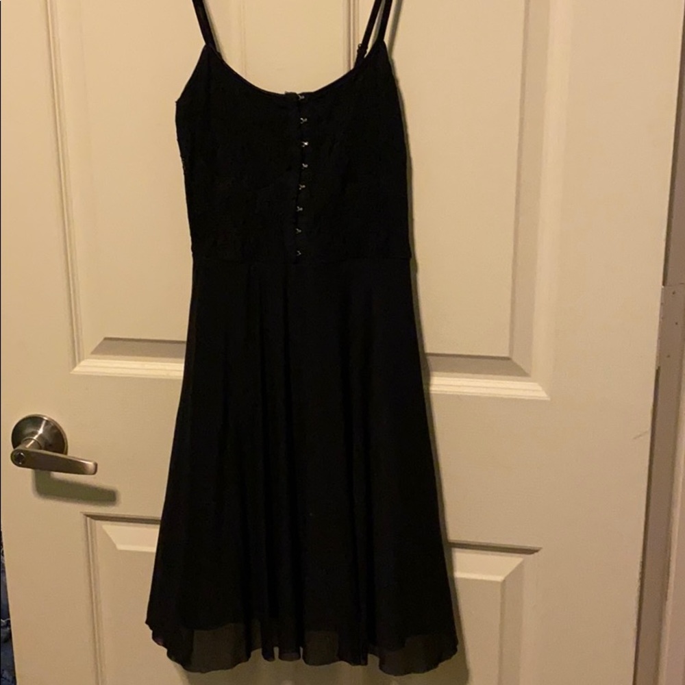Black dress with metal hooks in the front